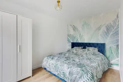 Un ou plusieurs lits dans un hébergement de l'établissement Appartement Suite aux Portes de Paris