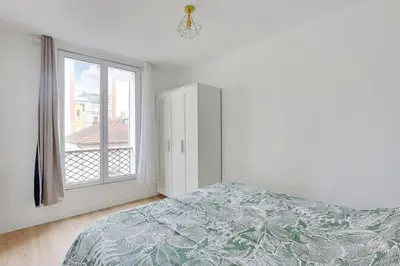 Un ou plusieurs lits dans un hébergement de l'établissement Appartement Suite aux Portes de Paris