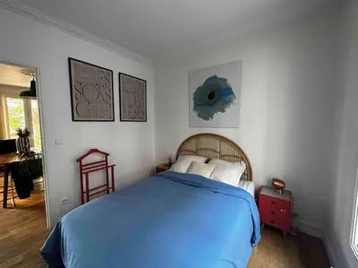 Un ou plusieurs lits dans un hébergement de l'établissement Charmant Appartement Parisien
