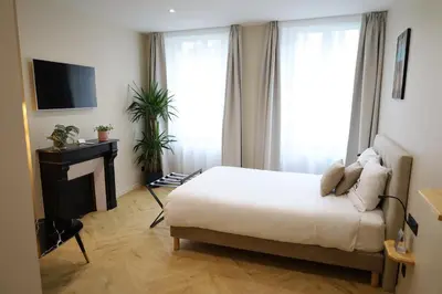 Un ou plusieurs lits dans un hébergement de l'établissement Les Chambres du Faubourg
