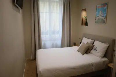 Un ou plusieurs lits dans un hébergement de l'établissement Les Chambres du Faubourg