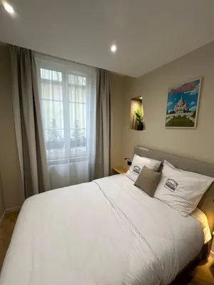 Un ou plusieurs lits dans un hébergement de l'établissement Les Chambres du Faubourg