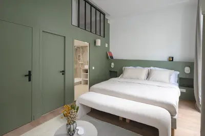 Un ou plusieurs lits dans un hébergement de l'établissement Noble Suites