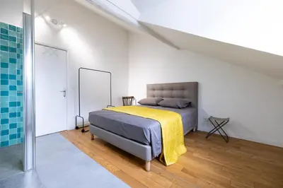 Un ou plusieurs lits dans un hébergement de l'établissement L'appartement du Cirque