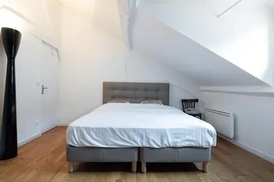 Un ou plusieurs lits dans un hébergement de l'établissement L'appartement du Cirque