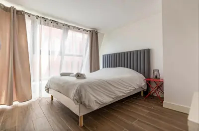 Un ou plusieurs lits dans un hébergement de l'établissement L'Escapade Paris