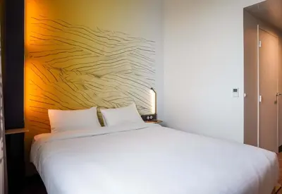 Un ou plusieurs lits dans un hébergement de l'établissement B&B HOTEL Paris Porte d'Orléans