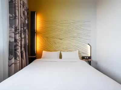 Un ou plusieurs lits dans un hébergement de l'établissement B&B HOTEL Paris Porte d'Orléans