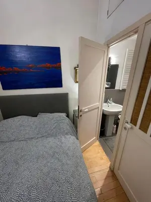 Un ou plusieurs lits dans un hébergement de l'établissement Romantique Suite Pont Neuf
