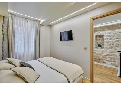 Un ou plusieurs lits dans un hébergement de l'établissement Apartment Le Marais place des Vosges by Studio prestige