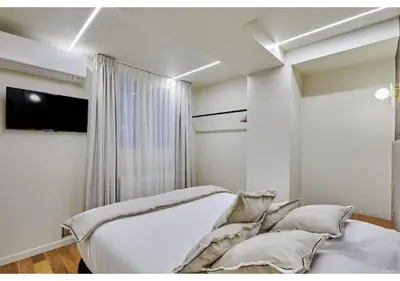 Un ou plusieurs lits dans un hébergement de l'établissement Apartment Le Marais place des Vosges by Studio prestige