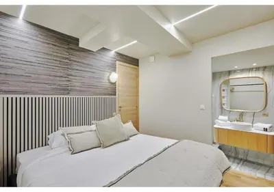 Un ou plusieurs lits dans un hébergement de l'établissement Apartment Le Marais place des Vosges by Studio prestige