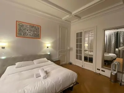 Un ou plusieurs lits dans un hébergement de l'établissement Deluxe Paris St Germain Suite