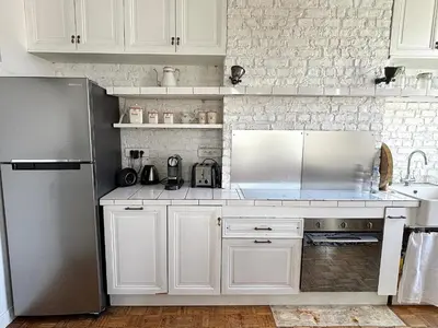 Cuisine ou kitchenette dans l'établissement L'appartement Poulbot