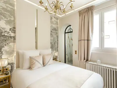Un ou plusieurs lits dans un hébergement de l'établissement Merveil - Signature Suite - Champs Elysees -Kleber