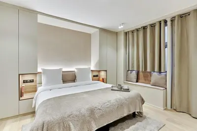 Un ou plusieurs lits dans un hébergement de l'établissement Studio Center of Paris by Studio prestige