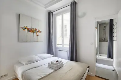 Un ou plusieurs lits dans un hébergement de l'établissement Apartment Center of Paris by Studio prestige