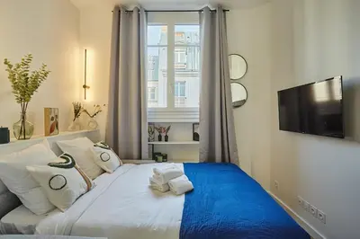 Un ou plusieurs lits dans un hébergement de l'établissement Studio Arc de Triomphe by Studio prestige