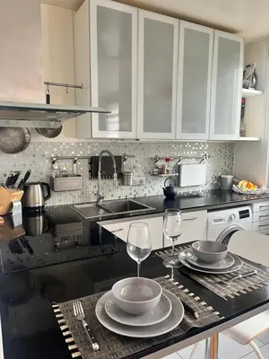 Cuisine ou kitchenette dans l'établissement Appartement cosy près de la Seine