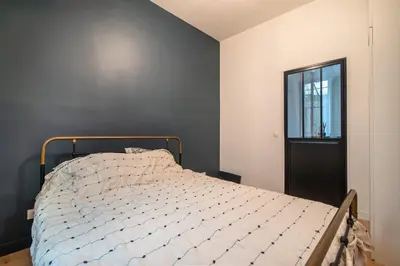 Un ou plusieurs lits dans un hébergement de l'établissement Charming and cosy apartment near Montmartre and Stade de France
