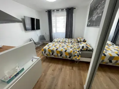 Un ou plusieurs lits dans un hébergement de l'établissement Appartement au Pied du Metro Mairie de Clichy L13