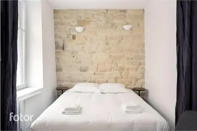 Un ou plusieurs lits dans un hébergement de l'établissement Suite Du Lion/AC Historic Flat, Marais, 4-5 Guests