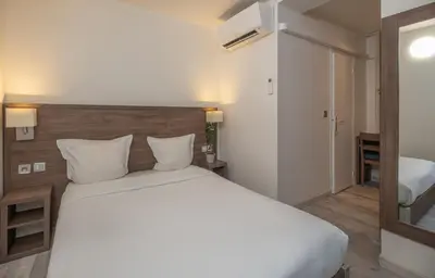 Un ou plusieurs lits dans un hébergement de l'établissement Hotel la Perle Montparnasse