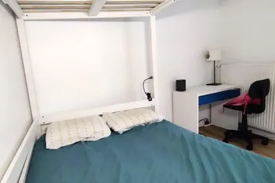 Un ou plusieurs lits dans un hébergement de l'établissement Appartement Jardin Seguin CityCosy