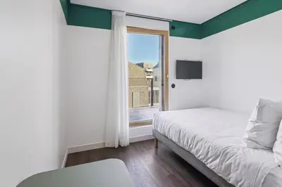 Un ou plusieurs lits dans un hébergement de l'établissement All Suites Appart Hôtel et Hôtel - Paris 13 - Porte d'Italie