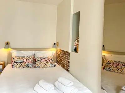 Un ou plusieurs lits dans un hébergement de l'établissement Studio cosy au cœur de Paris