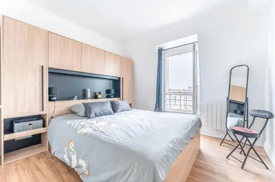 Un ou plusieurs lits dans un hébergement de l'établissement Charmant Appartement Proche Tour Eiffel