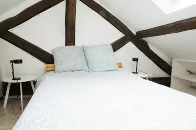 Un ou plusieurs lits dans un hébergement de l'établissement EXIGEHOME - Beau duplex-15 min Paris/La Défense/Champs Elysées