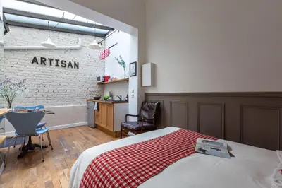 Un ou plusieurs lits dans un hébergement de l'établissement Artisan Lofts near Marais
