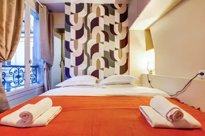 Un ou plusieurs lits dans un hébergement de l'établissement Le Marais - Les Halles Colorful & Modern 3BD