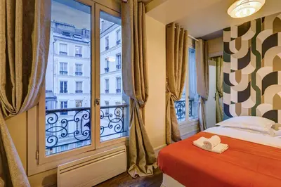 Un ou plusieurs lits dans un hébergement de l'établissement Le Marais - Les Halles Colorful & Modern 3BD