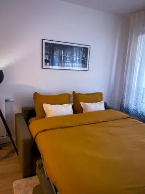 Un ou plusieurs lits dans un hébergement de l'établissement Grand appartement