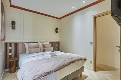 Un ou plusieurs lits dans un hébergement de l'établissement Apartment 3 bedrooms Center of Paris by Studio Prestige