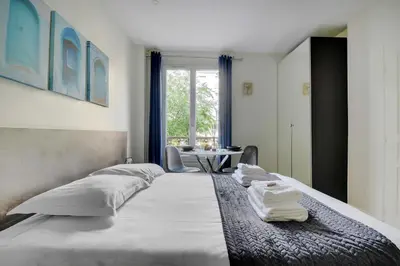 Un ou plusieurs lits dans un hébergement de l'établissement Comfort studio at Gare de l Est