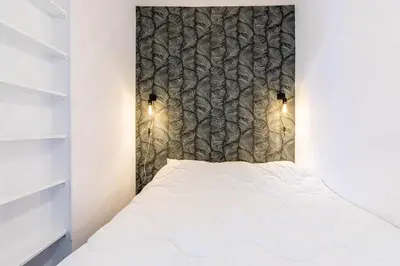 Un ou plusieurs lits dans un hébergement de l'établissement GuestReady - Cosy Nest near Place de la Bastille