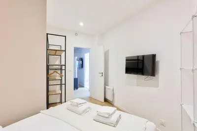 Un ou plusieurs lits dans un hébergement de l'établissement Charme Parisien 6 Personnes, 2 chambres, 19ème