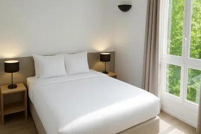 Un ou plusieurs lits dans un hébergement de l'établissement Cosy Studio La Defense