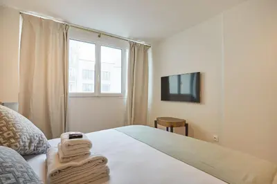 Un ou plusieurs lits dans un hébergement de l'établissement Résidence Centre de Paris by Studioprestige