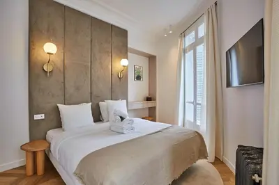Un ou plusieurs lits dans un hébergement de l'établissement Apartment Opera Vendome by Studio Prestige