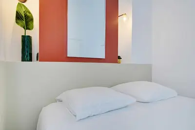 Un ou plusieurs lits dans un hébergement de l'établissement Apartment in the heart of the 9th arrondissement