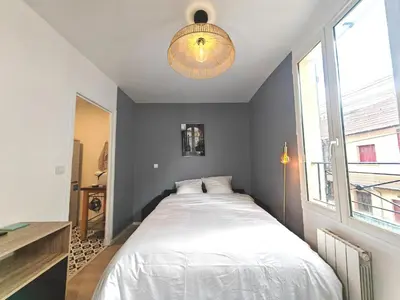 Un ou plusieurs lits dans un hébergement de l'établissement Cozy flat - Metro 13-14