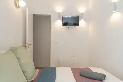 Un ou plusieurs lits dans un hébergement de l'établissement Lavie Maison AC and Balneo