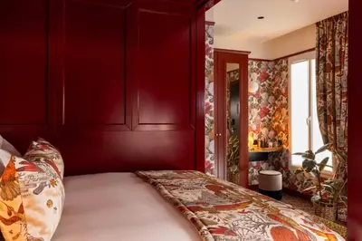 Un ou plusieurs lits dans un hébergement de l'établissement Hôtel Ginette à la Folie & Spa