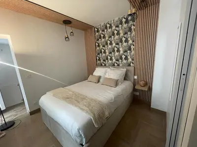 Un ou plusieurs lits dans un hébergement de l'établissement Eiffel tour Cosy Bali