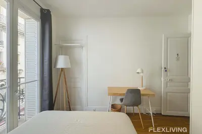 Un ou plusieurs lits dans un hébergement de l'établissement Flexliving - Room - Lamarck