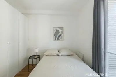 Un ou plusieurs lits dans un hébergement de l'établissement Flexliving - Room - Lamarck